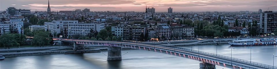 bridge over river during sunset